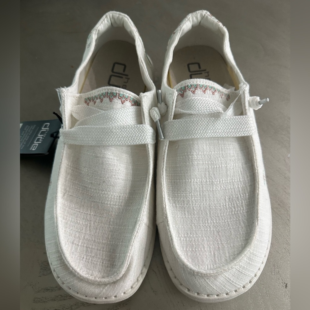 white hey dudes with pink and blue pattern on back